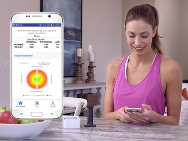 Person checking EyeQue numbers on app.