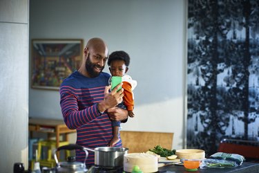 Man with baby son (6-11 months) at home