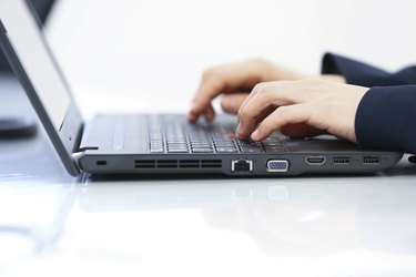 female hands typing on keyboard