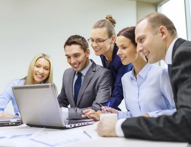 business team with laptop having discussion