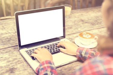 girl with a cup of coffee and a blank laptop