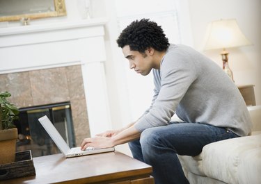 African man typing on laptop