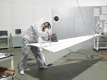 laboratory technician sanding paper plane