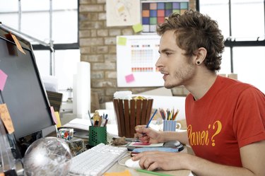 Designer focusing on his work on the computer