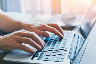 hands of business person working on computer