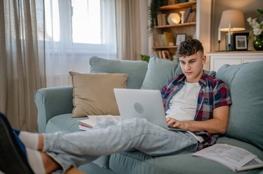 Young caucasian man teenager student study at home