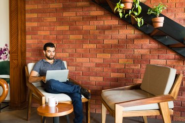 Relaxed latin man working on the laptop at the coffee shop