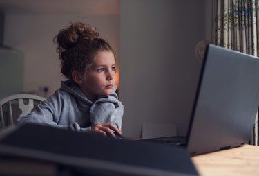 Young girl working on a laptop